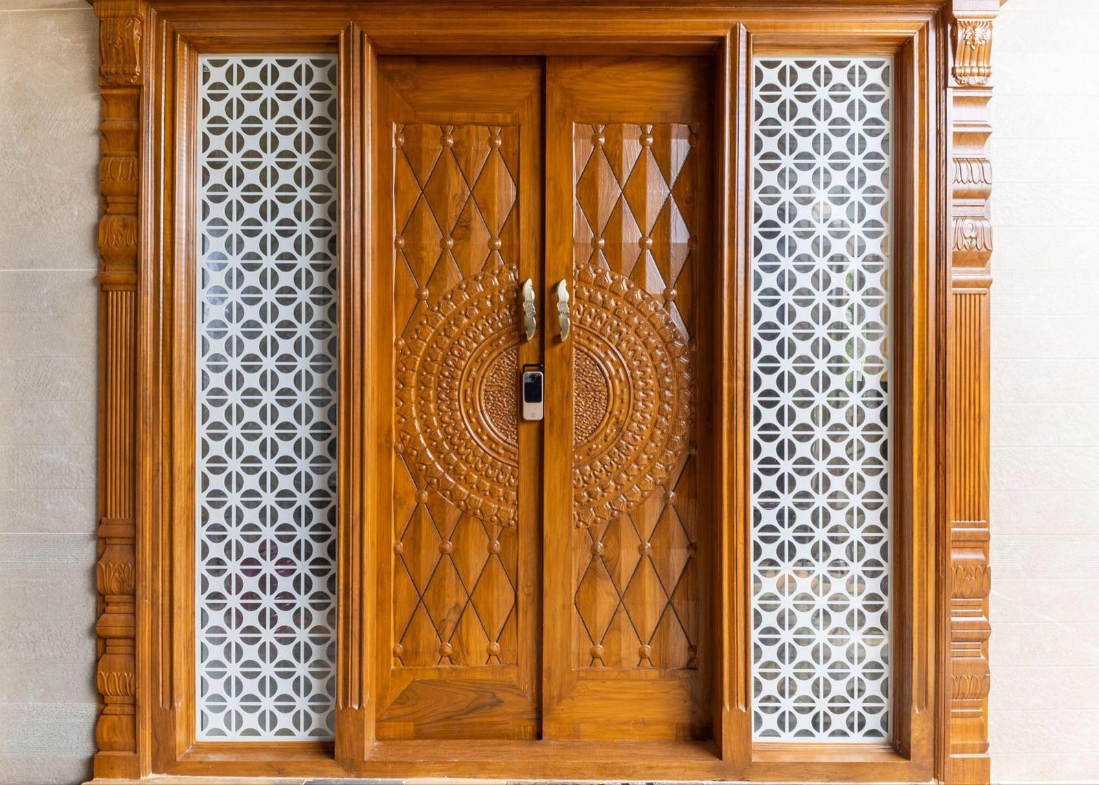 Carved teak entrance door with jaali side panels
