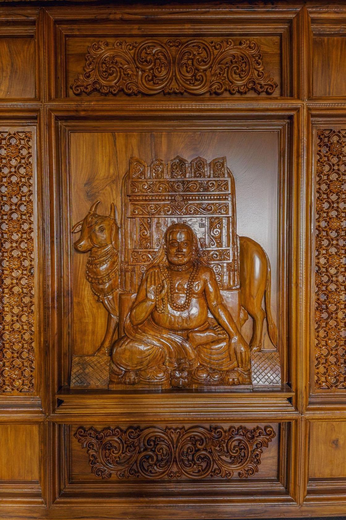 Hand-carved deity relief panel in teak
