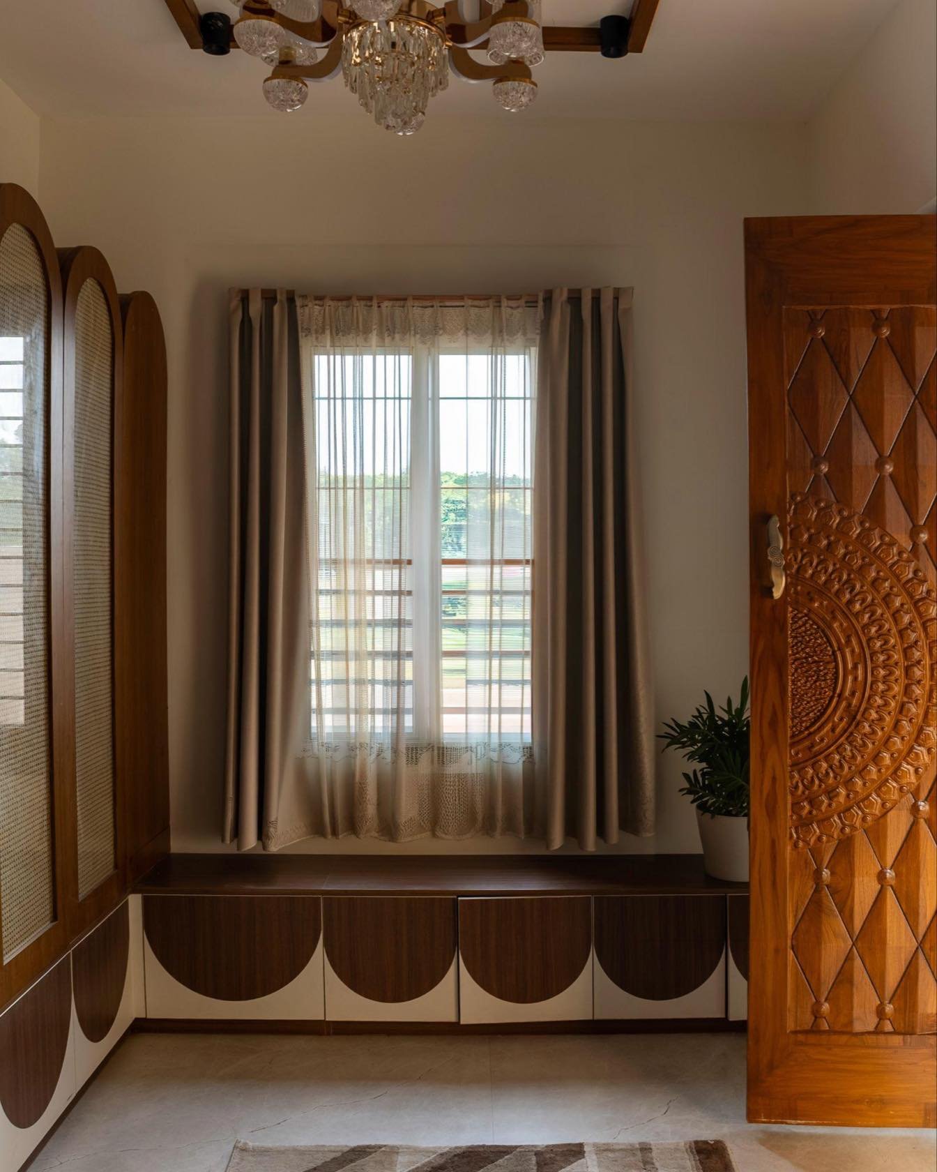 Window seat beside a carved jaali door