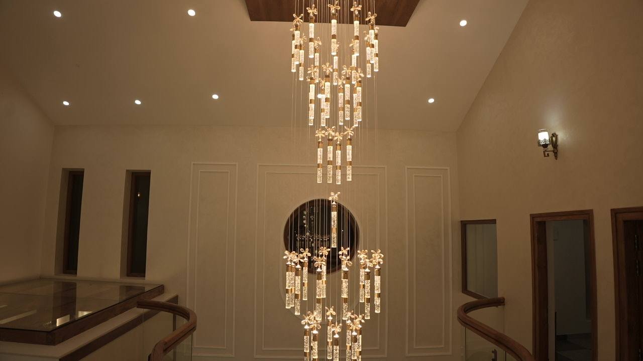 Crystal chandelier cascading through the double-height hall