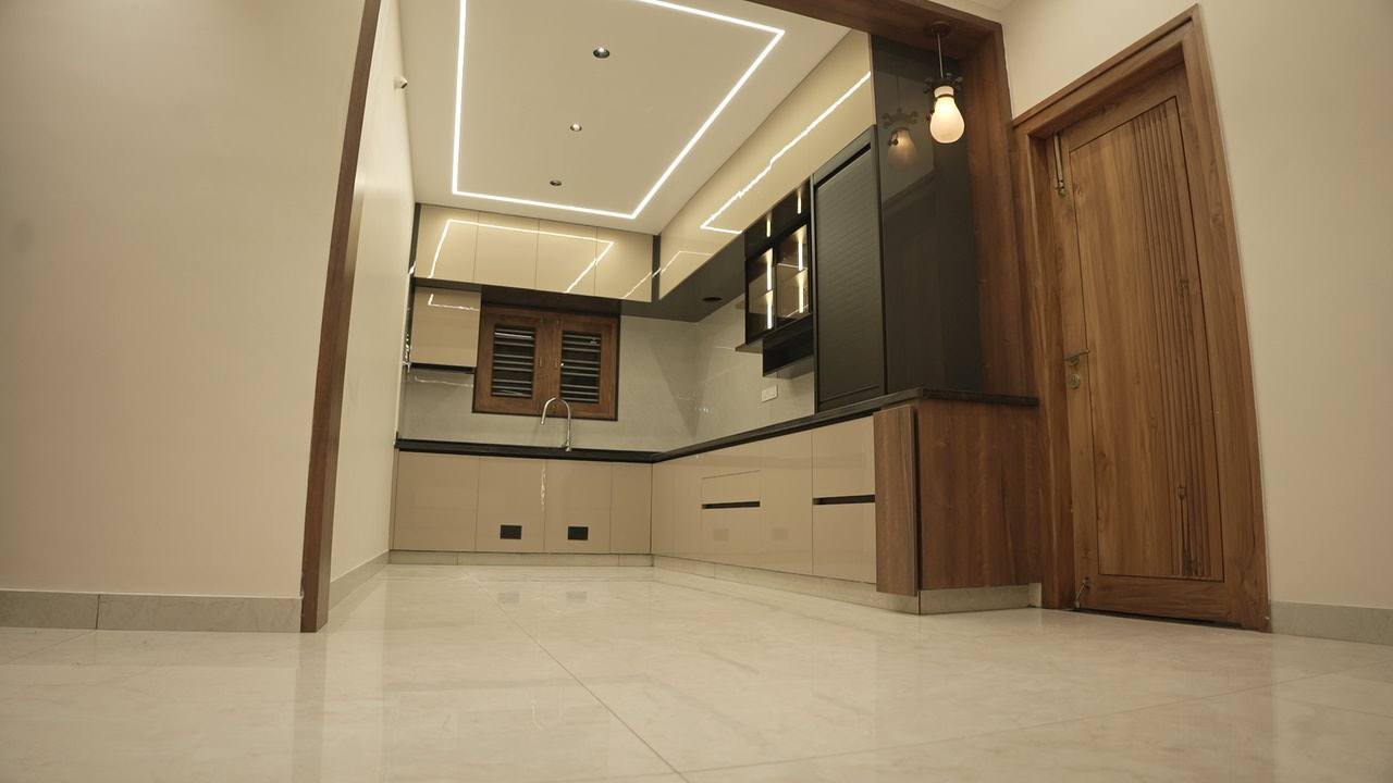 Kitchen with handleless cabinetry, profile ceiling lights and a timber door