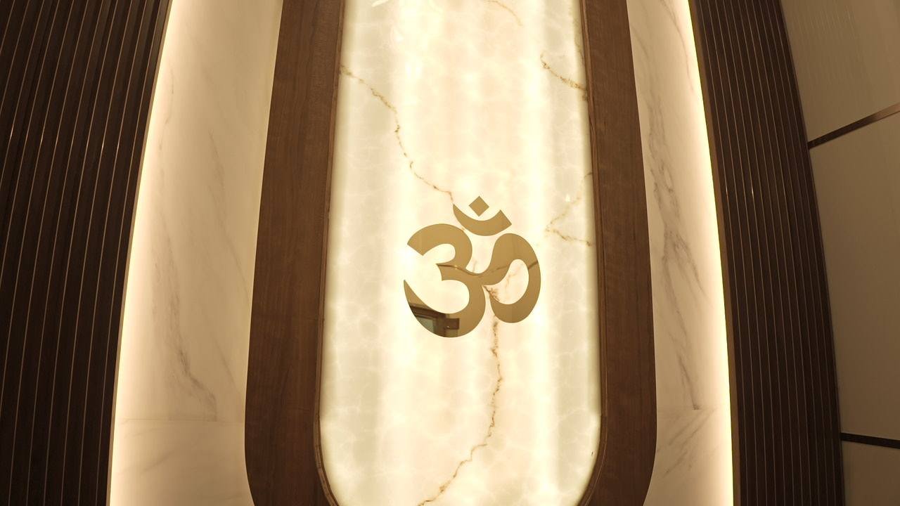 Brass Om set into a backlit alabaster arch framed by fluted timber